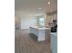 Open concept kitchen featuring a large center island with seating, and modern lighting at 7980 Syracuse Dr, Clermont, FL 34714