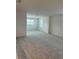 Spacious room featuring carpet flooring and natural light from the windows at 7980 Syracuse Dr, Clermont, FL 34714