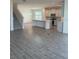 Living Room that opens to a spacious kitchen and staircase with carpet flooring at 7980 Syracuse Dr, Clermont, FL 34714