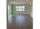 Open living room featuring sliding glass doors and tile floors offering nice backyard views at 7980 Syracuse Dr, Clermont, FL 34714