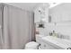 Well-lit bathroom features a tub, toilet, and storage shelves in a compact layout at 815 W Yale St, Orlando, FL 32804