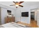Stylishly decorated bedroom with hardwood floors, a mounted TV, and elegant furnishings at 815 W Yale St, Orlando, FL 32804
