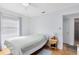 Bright bedroom features hardwood floors and a cozy bed with a view into the bathroom at 815 W Yale St, Orlando, FL 32804