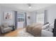 Bright bedroom with hardwood floors, neutral walls, and a comfortable chair by the window at 815 W Yale St, Orlando, FL 32804
