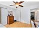 Bedroom featuring hardwood floors, a ceiling fan, and convenient access to adjacent rooms at 815 W Yale St, Orlando, FL 32804