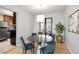 Bright dining room with modern lighting, seating for four, and view to kitchen at 815 W Yale St, Orlando, FL 32804