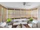 Comfortable sunroom with woven blinds, tiled floor, seating, and lots of light at 815 W Yale St, Orlando, FL 32804