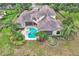 A luxurious backyard with a pool, spa, putting green, and lush landscaping at 9729 Lake Hugh Dr, Gotha, FL 34734
