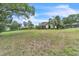 Large backyard featuring well-maintained lawn and landscaping, providing ample space and privacy at 9729 Lake Hugh Dr, Gotha, FL 34734