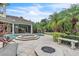 Backyard oasis with pool, hot tub, fire pit, and seating, ideal for outdoor entertaining and relaxation at 9729 Lake Hugh Dr, Gotha, FL 34734