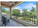 Balcony with wrought iron railing overlooking mature landscaping and lush greenery at 9729 Lake Hugh Dr, Gotha, FL 34734