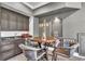 Game room wet bar featuring dark cabinetry, countertop seating, modern appliances, and a playful design at 9729 Lake Hugh Dr, Gotha, FL 34734