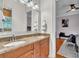 Elegant bathroom with granite countertop double vanity and view into the bedroom at 9729 Lake Hugh Dr, Gotha, FL 34734