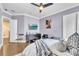 Bedroom with tv, en-suite bathroom, and wood floors at 9729 Lake Hugh Dr, Gotha, FL 34734