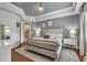 Primary bedroom with trey ceiling, neutral color palette, and decoratively accented walls at 9729 Lake Hugh Dr, Gotha, FL 34734