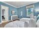 Bedroom featuring two twin beds, a dresser, and a window with a view of the neighborhood at 9729 Lake Hugh Dr, Gotha, FL 34734