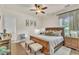 Cozy bedroom showcases a wooden bed frame, decorative pillows, and natural light at 9729 Lake Hugh Dr, Gotha, FL 34734