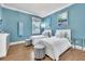 Bright bedroom featuring two twin beds, decorative pillows, and ample natural light at 9729 Lake Hugh Dr, Gotha, FL 34734