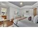 Bedroom with grey trey ceiling and wood floors, with a study nook visible in the distance at 9729 Lake Hugh Dr, Gotha, FL 34734