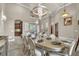 Open dining room featuring tiled floors, chandelier, set table and access to other living areas at 9729 Lake Hugh Dr, Gotha, FL 34734