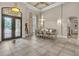 Open dining area with tile flooring, a chandelier, and a decorative iron front door at 9729 Lake Hugh Dr, Gotha, FL 34734