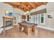 Elegant game room features custom wood ceiling, a pool table and a fireplace at 9729 Lake Hugh Dr, Gotha, FL 34734