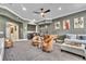 Entertainment room featuring a wet bar, gaming table, comfortable seating and modern decor at 9729 Lake Hugh Dr, Gotha, FL 34734