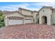 Home featuring a brick driveway and a spacious three-car garage with white doors at 9729 Lake Hugh Dr, Gotha, FL 34734