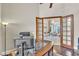 A home office with French doors leading to the main living area featuring hardwood floors at 9729 Lake Hugh Dr, Gotha, FL 34734