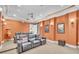 Home theater with recliner seating, decorative wall sconces, and tiered seating for an immersive experience at 9729 Lake Hugh Dr, Gotha, FL 34734