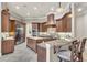 Spacious kitchen with custom wood cabinets, granite counters, a large island, and stainless steel appliances at 9729 Lake Hugh Dr, Gotha, FL 34734