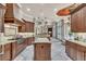 Gourmet kitchen featuring rich wood cabinetry, granite countertops, and a spacious center island at 9729 Lake Hugh Dr, Gotha, FL 34734
