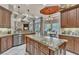 Open kitchen with granite countertops, custom cabinetry, stainless appliances, and seamless access to the dining area at 9729 Lake Hugh Dr, Gotha, FL 34734