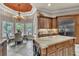 Bright and airy kitchen featuring a cozy breakfast nook with backyard views and stainless steel refrigerator at 9729 Lake Hugh Dr, Gotha, FL 34734