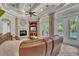 Cozy living room featuring a fireplace, custom shelving, and access to the outdoor living area and pool at 9729 Lake Hugh Dr, Gotha, FL 34734