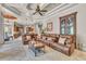 Expansive living room with leather seating, decorative ceilings, and convenient access to kitchen and breakfast nook at 9729 Lake Hugh Dr, Gotha, FL 34734