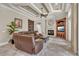 Inviting living room with a fireplace, custom built-ins, and coffered ceilings for a warm, spacious feel at 9729 Lake Hugh Dr, Gotha, FL 34734