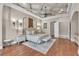 Spacious main bedroom with coffered ceilings, hardwood floors and ensuite bathroom at 9729 Lake Hugh Dr, Gotha, FL 34734