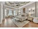 Luxurious main bedroom with tray ceilings, sitting area, and elegant decor at 9729 Lake Hugh Dr, Gotha, FL 34734
