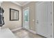A mudroom with a bench, mirror, and access to the outside at 9729 Lake Hugh Dr, Gotha, FL 34734