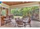 Covered patio featuring a dining table and bar area, offering a relaxing outdoor dining experience at 9729 Lake Hugh Dr, Gotha, FL 34734