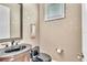 A powder room with a decorative mirror, dark fixtures, and elegant wallpaper at 9729 Lake Hugh Dr, Gotha, FL 34734