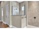 Walk-in shower boasts frameless glass, neutral tile, and decorative mosaic accents at 9729 Lake Hugh Dr, Gotha, FL 34734
