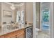 A wet bar area leading out to a pool featuring granite countertops and stainless steel wine cooler at 9729 Lake Hugh Dr, Gotha, FL 34734