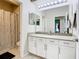 Bathroom featuring a large mirror above a white vanity with a granite countertop at 10875 Arbor View Blvd, Orlando, FL 32825