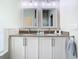 Bathroom featuring a double sink vanity with granite counters and white cabinets at 10875 Arbor View Blvd, Orlando, FL 32825