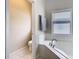 Bathroom showing a large tub with tile surround, with a toilet in the adjacent room at 10875 Arbor View Blvd, Orlando, FL 32825