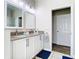 Bathroom featuring a double sink vanity, tile flooring, and bright lighting at 10875 Arbor View Blvd, Orlando, FL 32825