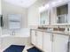 Bathroom featuring double sinks, a soaking tub, and a bright window at 10875 Arbor View Blvd, Orlando, FL 32825