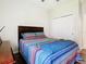 Bedroom featuring a cozy queen-sized bed, ceiling fan, and closet with doors at 10875 Arbor View Blvd, Orlando, FL 32825